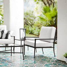 two chairs and a table on a tiled patio