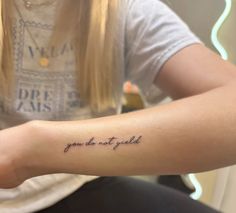 a woman with a tattoo on her arm that says you do not know what she is