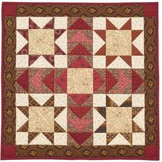 a red and brown quilt with white stars on it