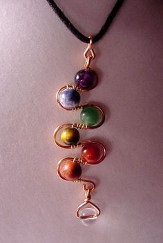 a necklace with five different colored stones on it