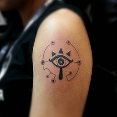 a man with a tattoo on his arm has an all seeing eye in the middle