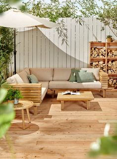 a living room filled with furniture and lots of greenery