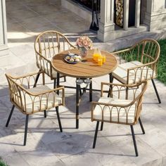 an outdoor table with four chairs around it