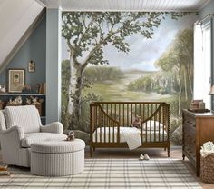 a baby's room with a large mural on the wall and a rocking chair