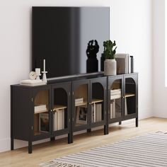 an entertainment center with bookshelves, vases and a mirror on the wall