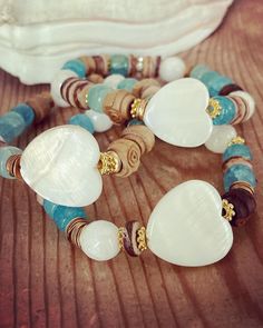 ✨ReLeasing 3 Sea DiPPerS bracelets inspired by my love of the Salt LiFe.  Luminous aqua beads are giving sea glass vibes, shimmering white mother of pearl hearts  combined with rustic vintage wooden rosette rosary beads are giving sand and washed sun vibes.  I have created two other coordinating bracelets to create the sea dipper stack. ✨ bracelets are made to fit a 6.5" wrist unless otherwise requested make your choice from drop down from one sea dipper only or the entire stack as shown in the 2nd photo. message with questions shipping is ground tracked insured Adjustable Beaded Heart Bracelet For Beach, Bohemian Heart Beads Bracelet For Beach, Handmade Heart Bracelet For Beach, Ocean-inspired White Bracelet As Gift, White Heart-shaped Beach Jewelry, Ocean-inspired White Bracelet Gift, Turquoise Heart Beads Bracelet For Beach, Heart-shaped Beaded Bracelets For The Beach, White Bohemian Bracelets With Heart Beads