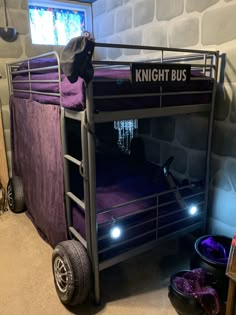 a bunk bed with lights on it in a room next to a tv and other items