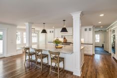 a large kitchen with white cabinets and wooden floors is featured in this postcard from the real estate website