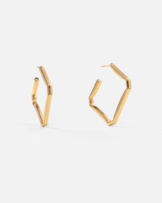 Slip these sleek folded square hoop earrings on, and add flair to your work, casual, or night wardrobe. Created with a deconstructed geometric shape and a subversive-basic design concept, these bright polished hoops exude modern minimalism.

Size: 43x42mm
Material: 18k Gold Plated On Brass 6 Fingers, Miao Silver, Square Hoop Earrings, Open Hoop Earrings, Basic Design, Earrings In Gold, Modern Minimalism, Recycled Sterling Silver, Made Goods