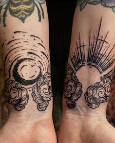 two people with tattoos on their arms holding hands