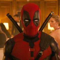 the deadpool character is dressed in red and black with two swords on his chest