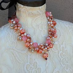 Copper Designer Inspired Twisted Wire Statement Necklace is made with a variety of beads and pearls in various shapes and shades of Pink and Copper. Many of the beads are acrylic so the piece is virtually weightless and Nickle Free.*** Beads and Pearls*** 18, 20 or 22 Inches in length with a Rhinestone Magnetic Clasp*** Twisted Wire*** Free Matching Dangle Earrings*** Free US Shipping*** Ships in 1 Day*** Gift Wrapping AvailableThis necklace was inspired by my favorite Designer Pearl Necklace bu Pink Gemstone Beads Necklaces For Party, Pink Gemstone Beads Necklace For Party, Party Pearl Necklace With Round Gemstone Beads, Pearl Necklaces With Large Beads For Gifts, Pink Pearl Beaded Necklaces For Parties, Elegant Pink Pearl Necklace With Colorful Beads, Pearl Necklaces With Colorful Beads For Party, Party Pearl Necklaces With Large Beads, Pearl Necklace With Colorful Beads For Party