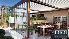 an outdoor dining area with tables and chairs