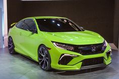 a bright green car is on display at an auto show