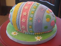 there is a cake that has been decorated with many different colors and designs on it