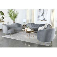 a living room with two grey couches and a round coffee table in the middle