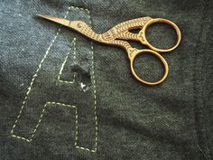 a pair of scissors sitting on top of a piece of fabric