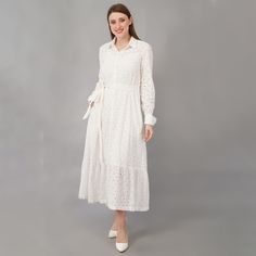 This eyelet shirt dress in white color of cotton is the epitome of class. The perfect summer dress is a must have for all the occasions. - Shirt collar neck - Flared silhouette - Long sleeve - Ankle length - Button down - White cotton fabric belt - Pockets on both the sides - includes cotton slip Color - white  Fabric - 100% cotton eyelet SIZES: Please see the size chart image and pick the size that works for you. We are happy to make minor alterations to help create the right fit. Please let us know.  CUSTOMIZATIONS: We are happy to make minor adjustments to help craft the perfect fit.  PLEASE NOTE what you get may not match exactly with the photos and may vary slightly in color and pattern due to lighting and camera settings. We try to be as true as possible to the photographs and are ha White Button-up Feminine Midi Dress, White Cotton Shirt Dress For Daytime, White Button-up Feminine Shirt Dress, White Feminine Button-up Shirt Dress, White Shirt Dress For Spring, White Long Sleeve Eyelet Dress, White Eyelet Midi Dress For Day Out, White Cotton Button-up Midi Dress, Shirt Dress With Pockets