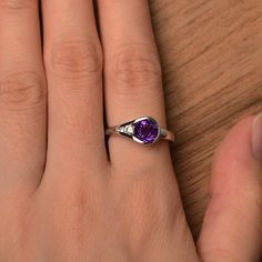 It is a natural purple amethyst ring. The main stone is 7mm*7mm round, weight about 1.61 carats. The basic metal is sterling silver and plated with rhodium. To change the metal to a solid gold (white/rose) or platinum is also available, please ask for a quotation if you want. You can also go to my shop Home for more elegant rings: https://www.etsy.com/shop/godjewelry?ref=hdr_shop_menu Amethyst is the birthstone of February. More amethyst rings: https://www.etsy.com/shop/godjewelry?ref=hdr_shop_m Purple Cubic Zirconia Birthstone Ring, Amethyst Birthstone Ring With Round Cut, Purple Round Cut Birthstone Ring With Center Stone, Round Amethyst Birthstone Ring In Fine Jewelry Style, Amethyst Diamond Birthstone Ring With Round Cut, Amethyst Round Cut Diamond Ring Birthstone, Amethyst Round Cut Diamond Birthstone Ring, Amethyst Diamond Ring With Round Cut, Sterling Silver Purple Birthstone Ring With Center Stone