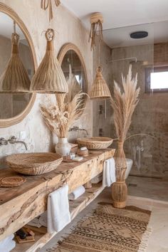 a bathroom with two sinks, mirrors and baskets on the counter top in front of it