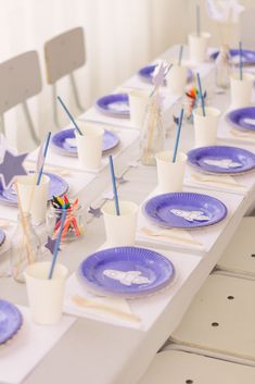 the table is set with paper plates and cups