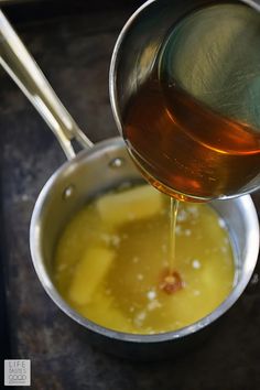 a pot filled with liquid next to a spoon