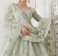 Dusty Mint Green Designer Heavy Embroidered Bridal Lehenga-Saira's Boutique Fitted Pista Green Sets For Reception, Fitted Saree Set With Intricate Embroidery, Designer Wear Pista Green Gown, Fitted Embroidered Fabric With Traditional Drape, Fitted Traditional Wear With Sheer Dupatta In Pista Green, Bollywood Style Lehenga With Long Sleeves In Pista Green, Pista Green Gown With Sheer Dupatta, Fitted Pista Green Traditional Wear With Sheer Dupatta, Pista Green Sharara With Self Design For Wedding