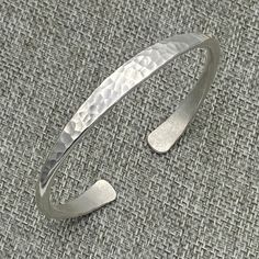 ❋ Handmade Sterling Silver Adjustable Minimalist Design Cuff Bracelet, Hammered Shiny Silver ❋ Width: 1/4 inch (7mm) ❋ Size: Medium women size, Length (end to end, without the gap): 6 1/2 inches / 16.6cm ❋ Metal Purity: 95% Pure Silver (Purer than sterling Silver - 92.5%) Wider hammered silver cuffs: https://www.etsy.com/listing/256824170 https://www.etsy.com/listing/250878986 https://www.etsy.com/listing/173665269 Matching style Cuff Rings: https://www.etsy.com/listing/176672865 https://www.ets Resin Paper, Boho Cuff Bracelet, Statement Cuff Bracelet, Boho Cuff, Handmade Silver Jewellery, Cuff Bracelets Handmade, Stackable Bangles, Indie Jewelry, Jewelry Showcase