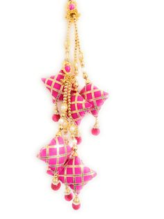 a pink and white ornament hanging from a gold - plated metal chain