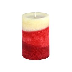 a red and white candle sitting on top of a table