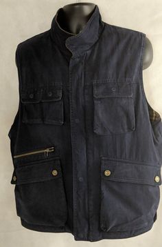 "Vintage Woolrich Sportsman Vest  Tactical Vest  Work Wear Insulation - 70% Cotton 30% Nylon 100% Cotton Shell Body Lining - 100% Cotton Cleaned & stored in a non-smoking pet-free environment Approximate Measurements: Chest - 48\" Shoulder to Shoulder - 17\" Underarm to Underarm - 24\" Length Collar to Hem - 29\"" Utility Tops With Side Pockets For Outdoor, Military Tops With Pockets For Outdoor Activities, Cotton Outdoor Top With Multiple Pockets, Outdoor Cotton Top With Multiple Pockets, Cotton Military Tops For Outdoor Activities, Vintage Woolrich, Tactical Vest, Mens Vests, Outdoor Fashion