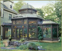 a gazebo in the middle of a yard next to a house