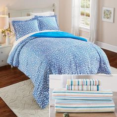 a bed with blue and white comforters in a bedroom