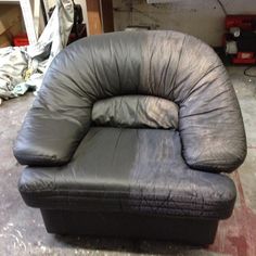 a black leather chair sitting on top of a hard wood floor