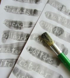 a green brush sitting on top of some paper