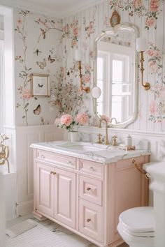 a bathroom with floral wallpaper and pink vanity