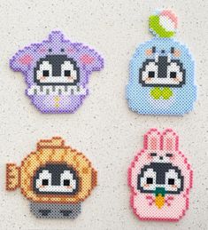 four cross stitch animal designs on a white surface