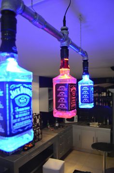 two lighted bottles are hanging from the ceiling