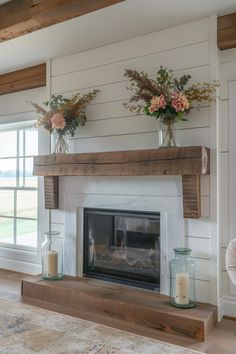 a living room with a fire place and two vases on top of the mantle