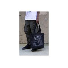 Our oversized tote bag is designed to be durable for your daily needs.The front and back are adorned with Basquiat's album cover artwork Beat Bop. 100% heavy duck canvas in black Lined with 100% cotton Cotton webbing handles 18x17 inches (45.7x43.2 cm) Made in the USA About the artwork: One of Jean-Michel Basquiat's most coveted works is from the record album artwork of the early hip-hop record Beat Bop that JMB produced and self-financed. Released under his own Tartown record label, the origina Rectangular Canvas Streetwear Bags, Rectangular Canvas Bags For Streetwear, Urban Tote Bag For Streetwear, Black Cotton Bag For Streetwear, Urban Streetwear Tote Bag, Urban Black Cotton Bag, Canvas Tote Bag For Streetwear, Graphic Print Tote Bag For Streetwear, Black Bags With Graphic Print For Streetwear