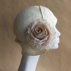 Emilia Cloche Hat. Stylish cloche by And They Loved Hats in off white straw with ivory/beige silk rose. This hat features an eyecatching sculpted tuck brim and an intricate side pleated asymmetric art deco style side brim. Perfect for Summer gatherings and evening soirees.  YOUR SIZE inches or centimeters 21" | 53-54cm 21.5" | 54-55cm 22" | 56cm 22.5" | 57-58cm 23" | 58-59cm 23.5" | 60cm Place a tape measure on your forehead just above the eyebrow. Fit it around your head, ensuring that the wide Elegant Hat With Structured Crown In Natural Color, Elegant Natural Hat With Structured Crown, Fitted Cream Cloche Hat With Curved Brim, Fitted Cream Cloche Hat For Wedding, Cream Brimmed Cloche Hat For Evening, Beige Cloche Hat For Wedding, Fitted Beige Cloche Hat For Church, Elegant Adjustable Bonnet For Summer, Beige Cloche Hat For Church