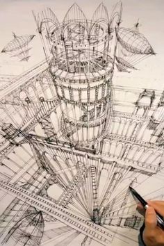 a person is drawing something on a piece of paper that looks like a tower structure