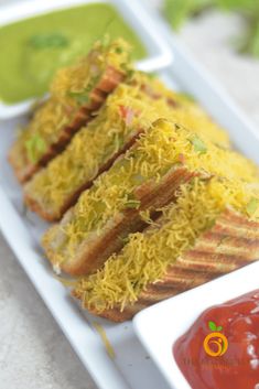 some food on a white plate with sauces and condiments in the background