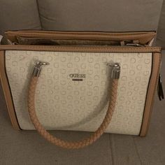 This Guess Handbag/Shoulder Bag/Satchel Is Brand New And Never Been Used. It Still Comes With The Paper Wrap That Was Inside Of It When Bought, And The Tag. It Has 3 Pockets Inside The Bag Pictured In The Photos, And The Pocket With The Guess Logo Is Magnetically Sealed. The Shoulder Strap On It Is Detachable. Cream Double Handle Satchel For Office, Beige Satchel For Office, Cream Satchel Shoulder Bag, Cream Handheld Satchel With Handles, Handheld Cream Satchel With Handles, Cream Satchel Shoulder Bag With Handles, Cream Crossbody Satchel With Handles, Cream Handheld Satchel For Errands, Handheld Cream Satchel For Errands