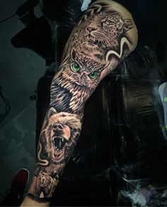 an owl and bear tattoo on the arm with green eyes is shown in this photo