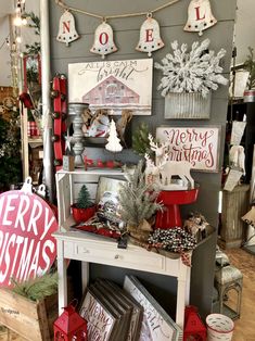 christmas decorations and signs on display in a store