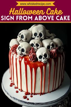 a halloween cake with skulls on top and red sauce drizzled over it