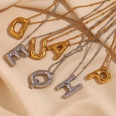 Add some playful personalization to your summer wardrobe with our Bubble Letter Necklace! This quirky accessory is a perfect gift for her, adding a fun touch to any outfit. Layer it up for a fun #neckmess! DETAILS & SIZE Finish: 18K gold plate Materials: 316L Stainless Steel Measurements: Pendant: 19.4x14.4mm; Chain: 16" + 2" extension Lobster claw clasp Waterproof, tarnish-resistant, and nickel free. Shop Necklaces for more options! Bubble Letter Necklace, Gold Initial Necklace, Bubble Letter, Silver Water, Letter Pendant Necklace, Initial Necklace Gold, Letter Design, Letter Balloons, Waterproof Jewelry