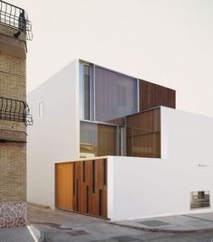 a white building sitting next to a tall brick building