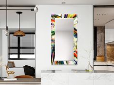 a mirror hanging on the wall above a counter in a room with white walls and marble counters